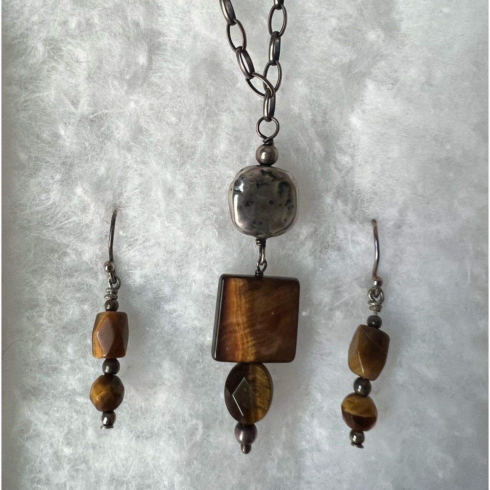 Silpada necklace w/ complimentary earrings.  Tiger’s eye and sterling silver.